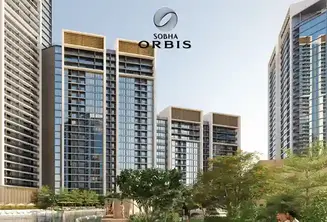 Tall modern towers of Sobha The Element at sunset with road and cars in foreground